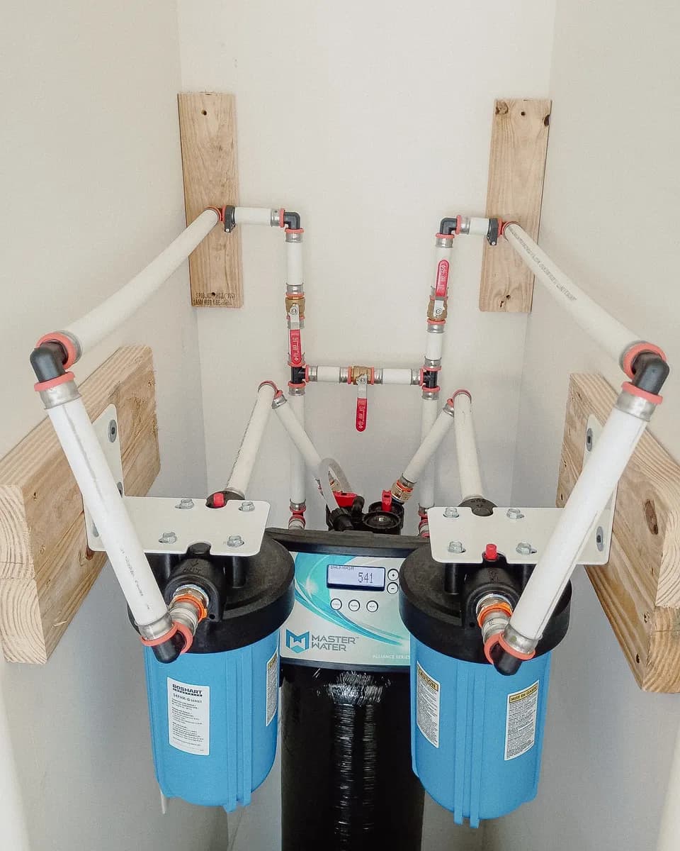 Twin whole-home water filters plumbed on either side of a softener